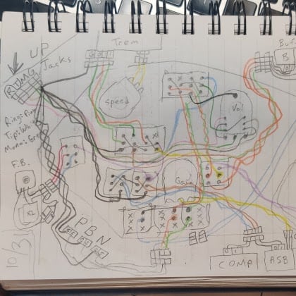 a notebook with the circuit wiring sketched out in color pencil